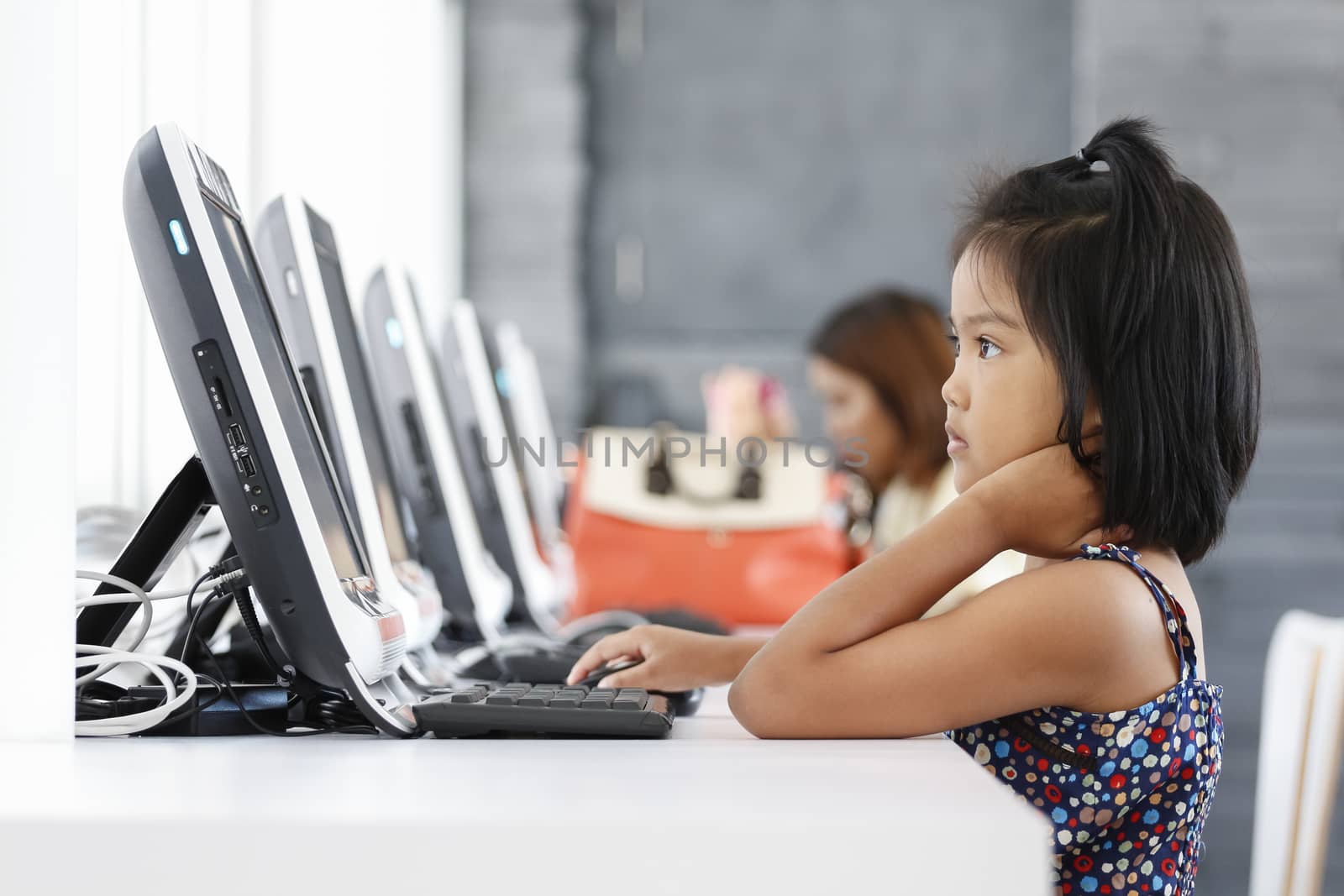 Asian children to playing with computer