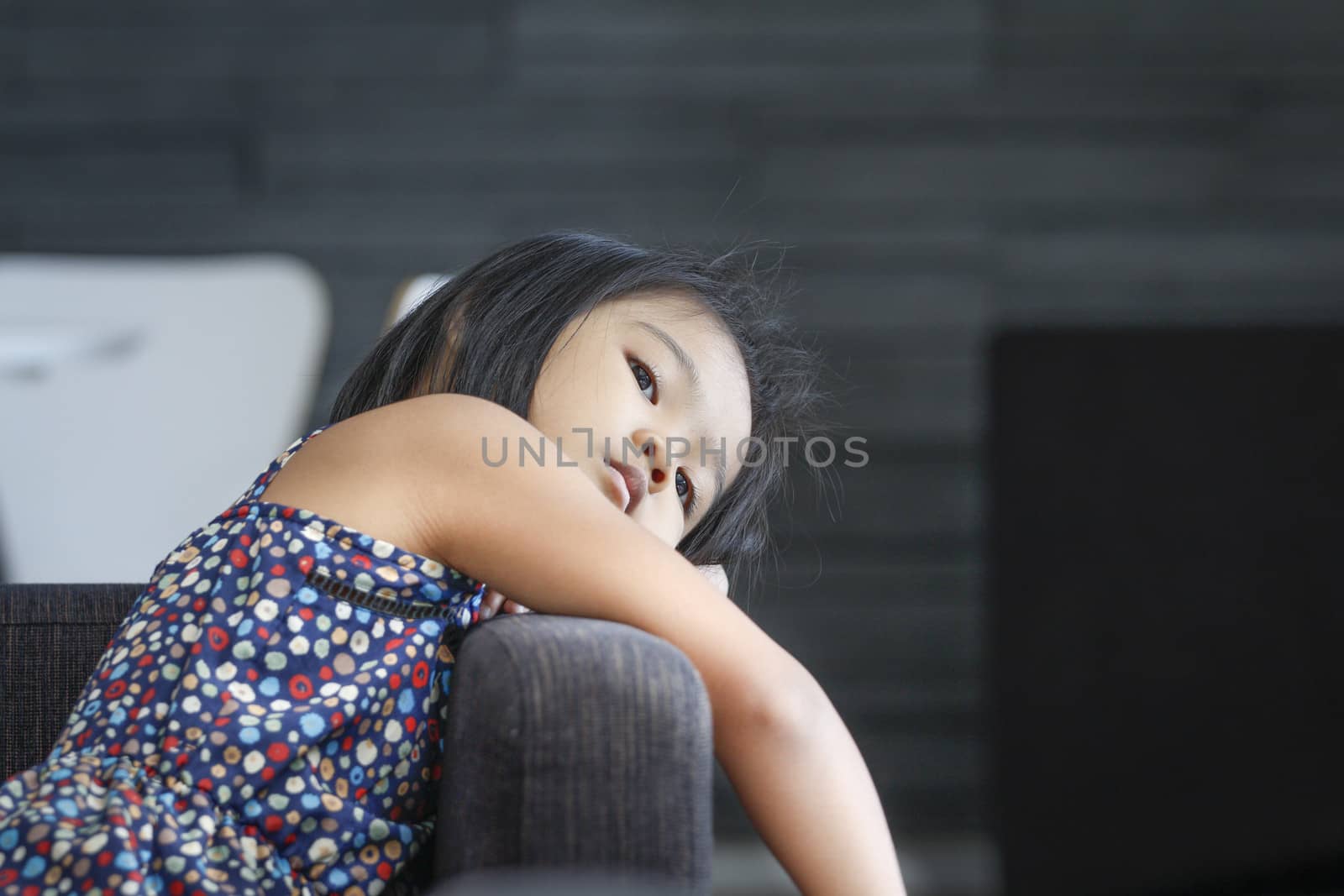 Relaxing time of asian children on sofa