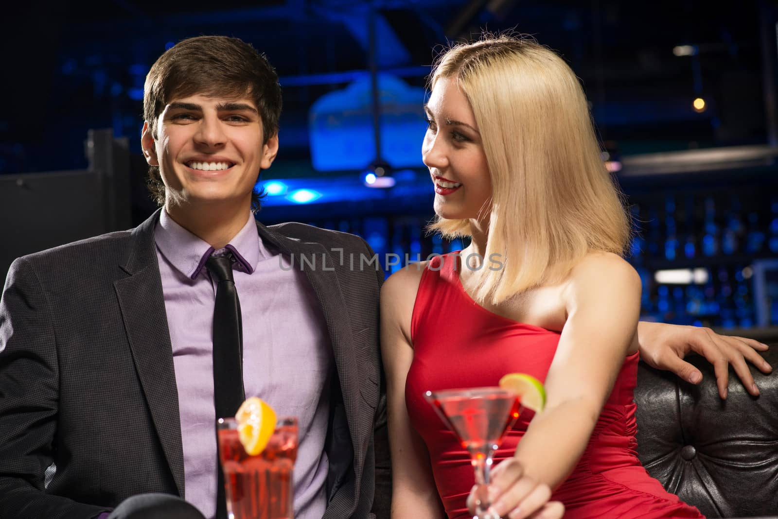 Young couple talking in a nightclub, have fun