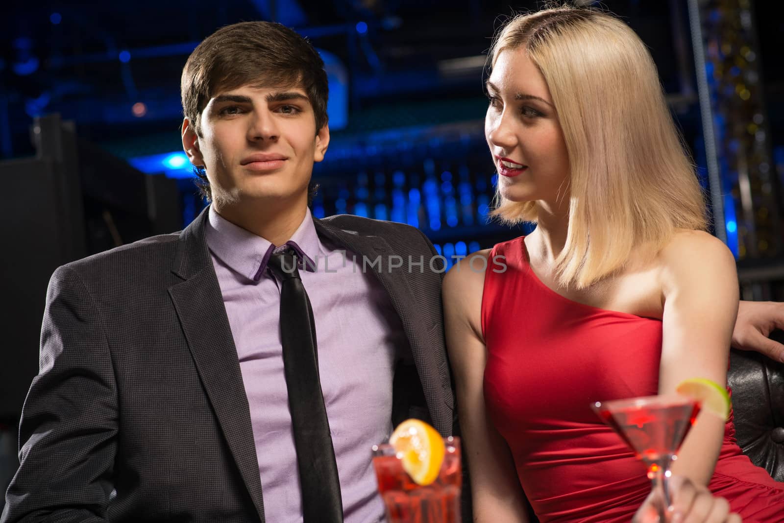 Young couple talking in a nightclub by adam121