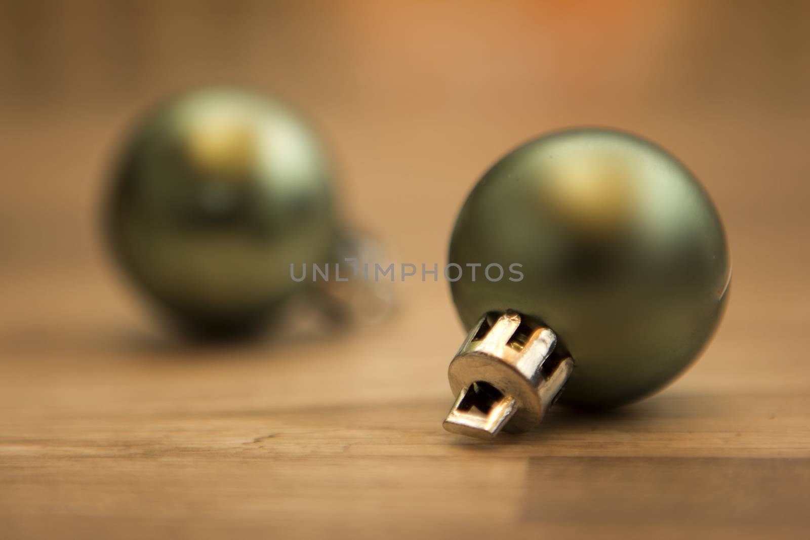 two christmas baubles green with wooden background 