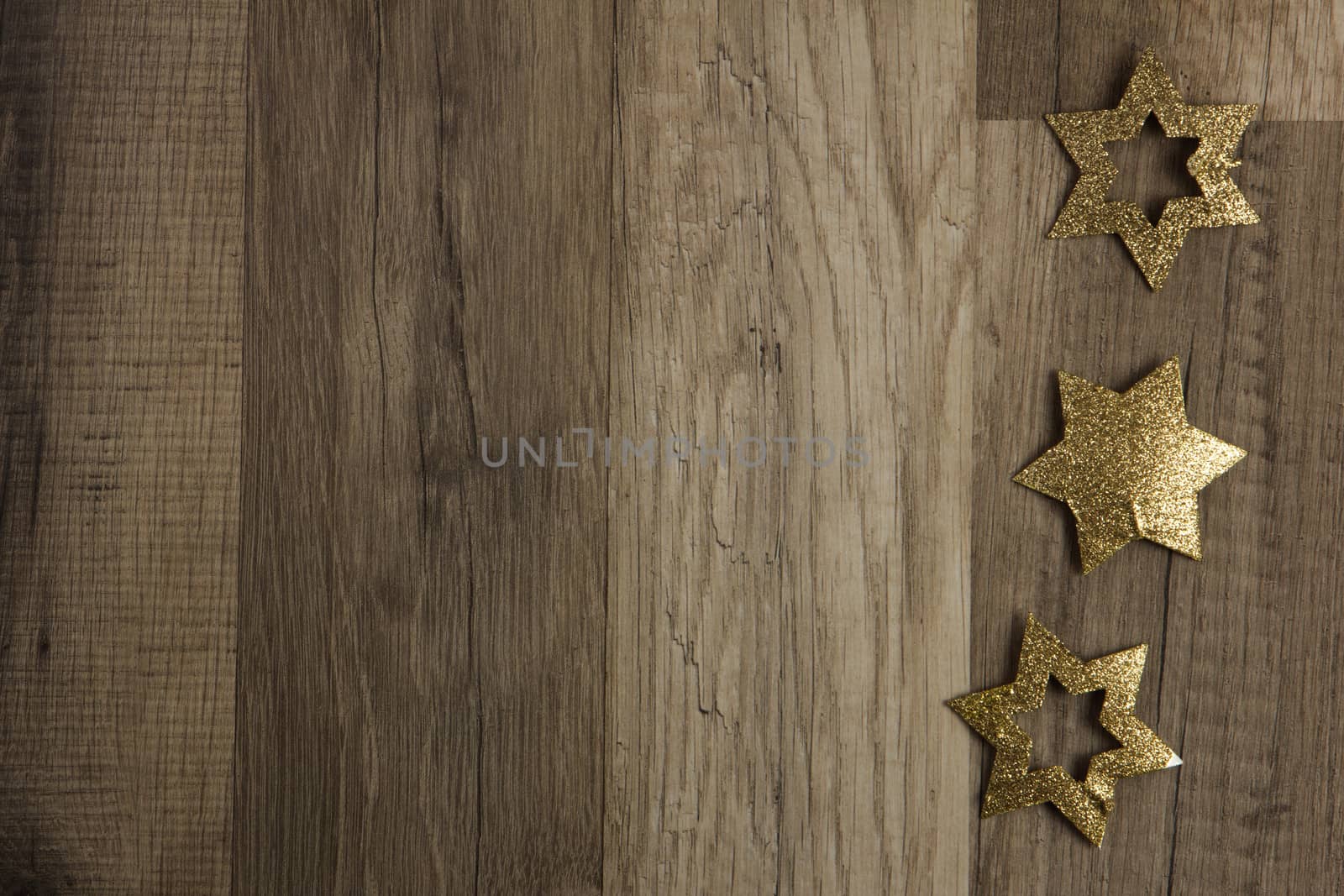 moravian stars as christmas decoration gold on wooden background 