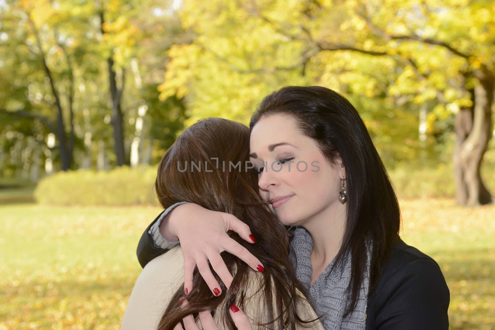 girlfriends hugging in autumn park