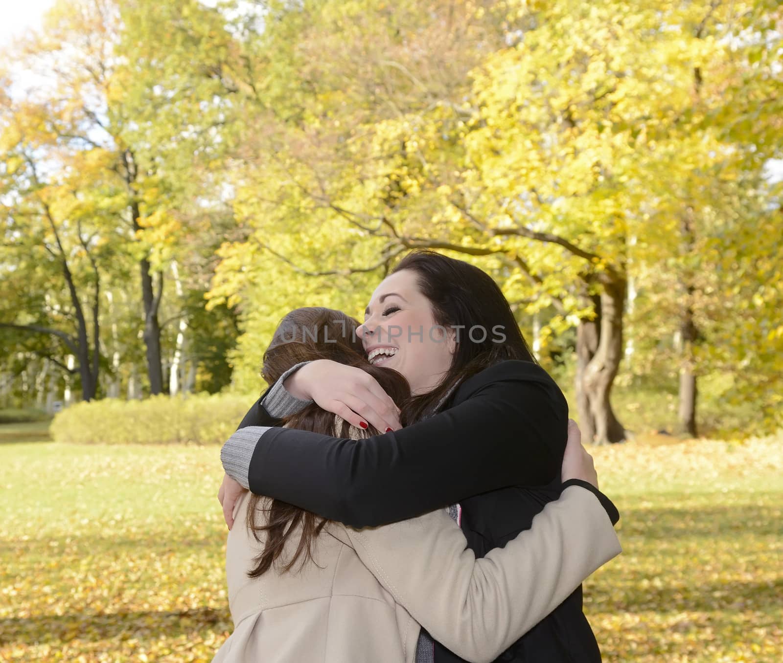 girlfriends hugging in autumn park