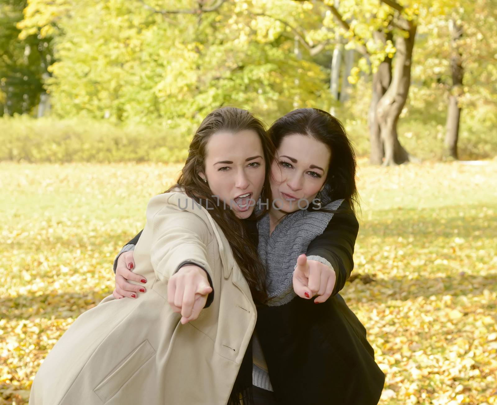 two women pointing with forefinger