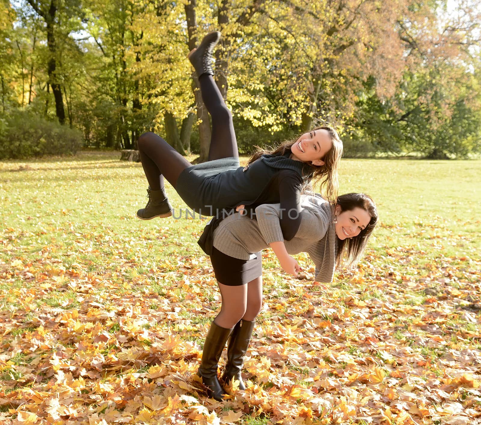 lively girlfriends in autumn park