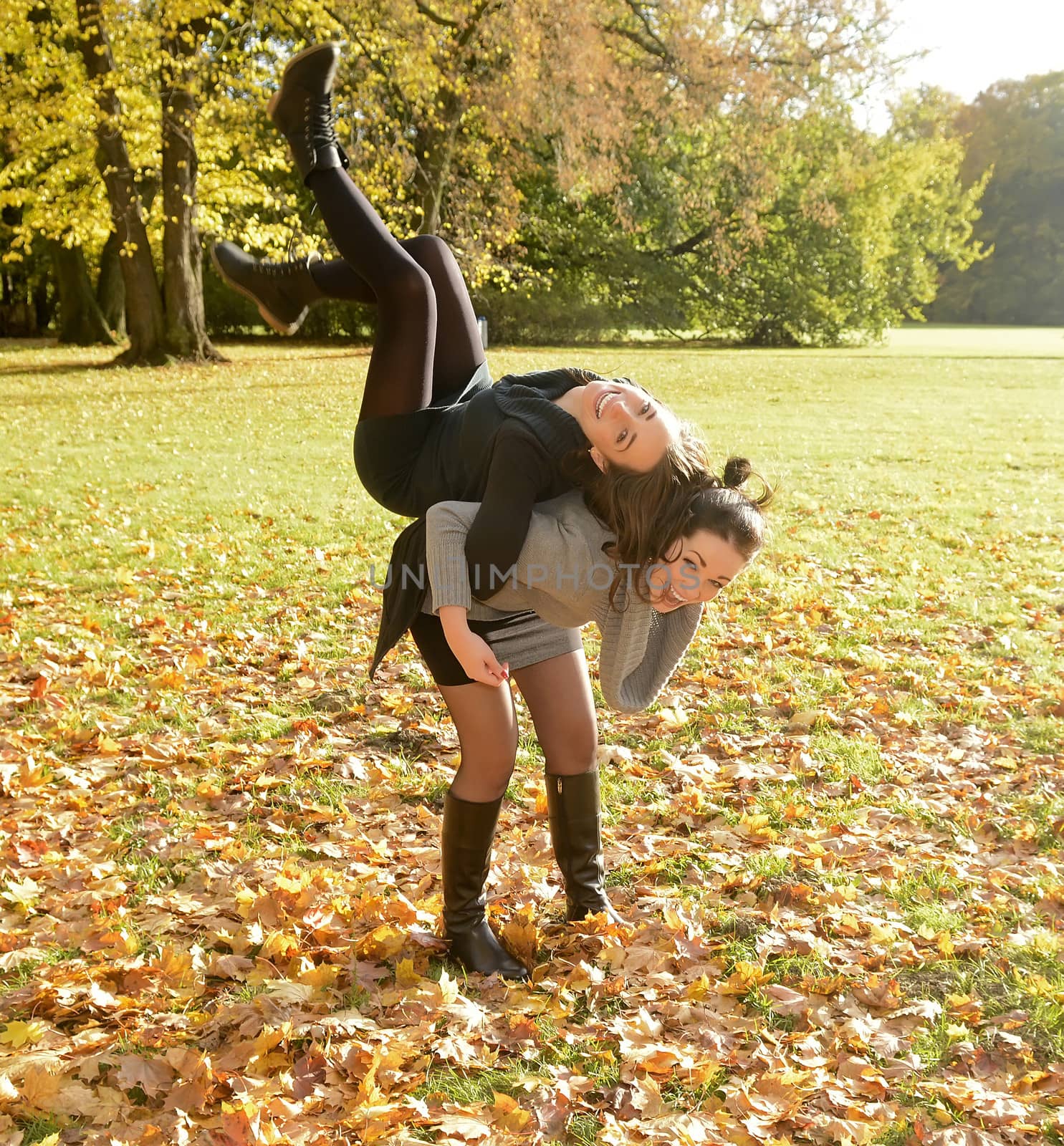 lively sisters in autumn park