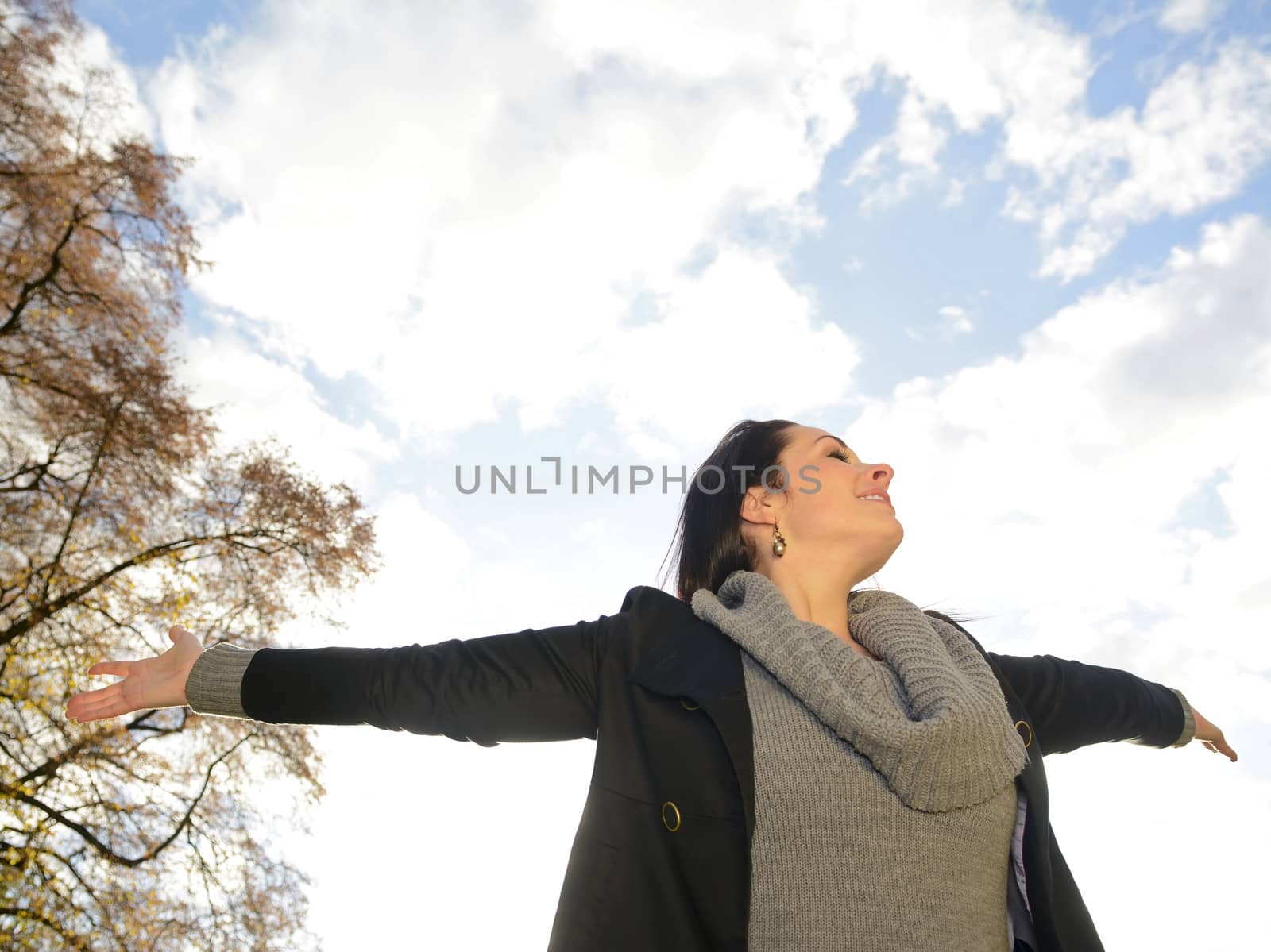  beautiful young woman cheering, closed eyes