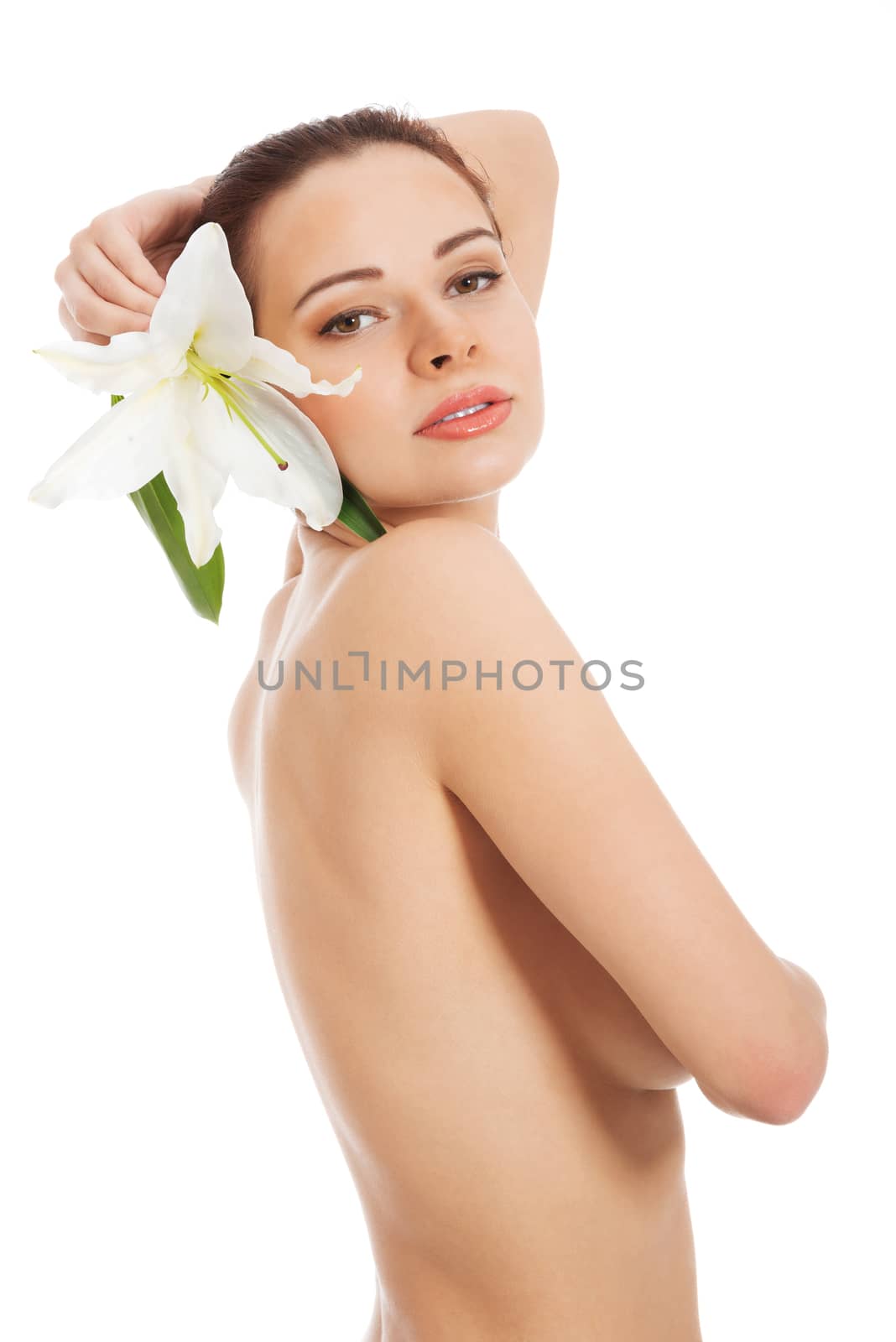 Beautiful topless woman with white lily. Isolated on white.