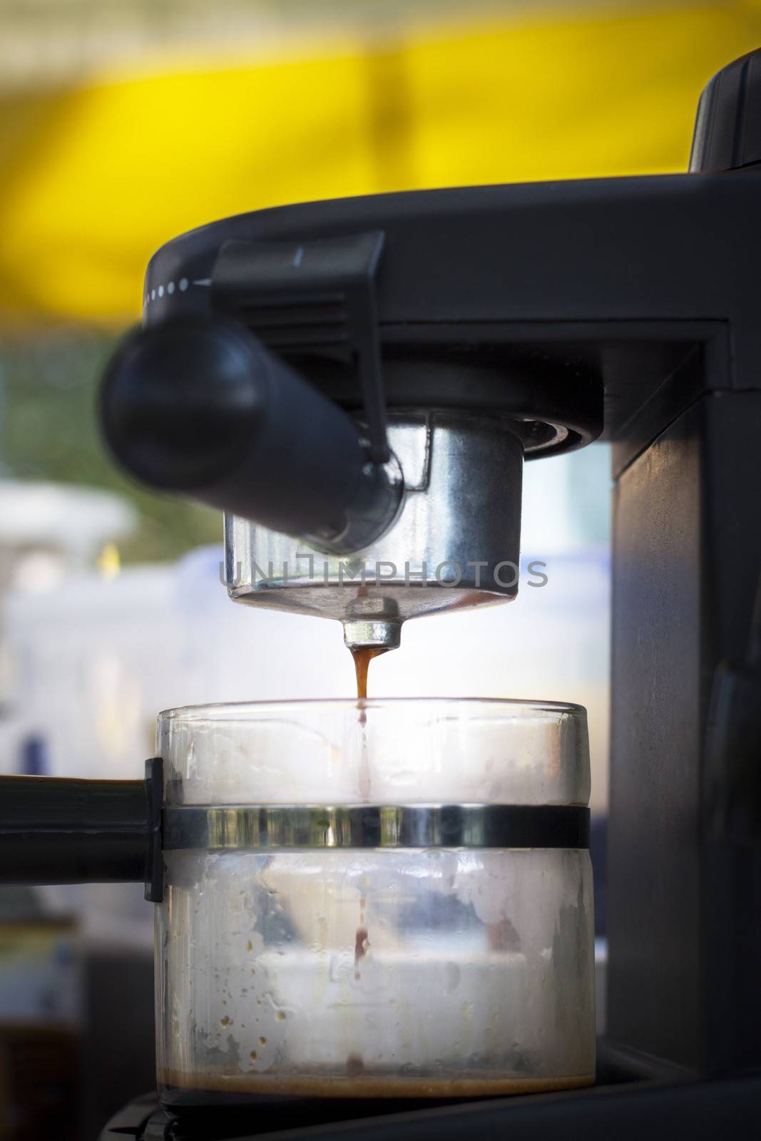 coffee maker machine droping coffee liquid in to glass mug use for coffe shop or hot drinking in restaurant background by khunaspix
