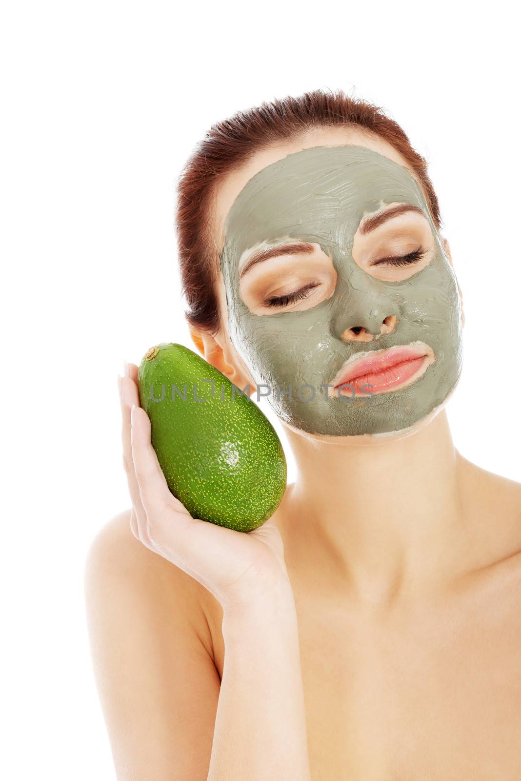 Beautiful woman with facial mask holding avocado and closed eyes. Isolated on white.