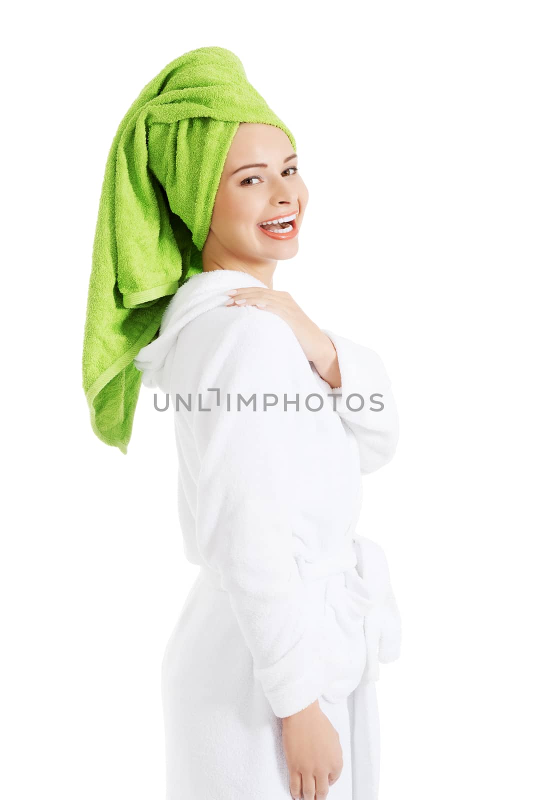 Beautiful woman in turban and bathrobe. Isolated on white.