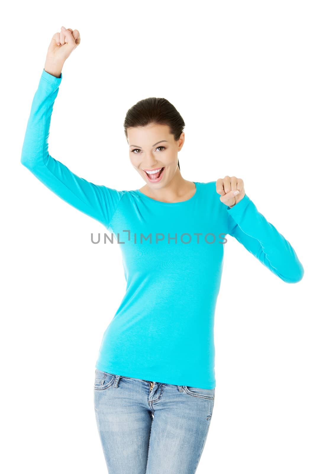 beautiful casual woman with raised fists. Isolated on white.