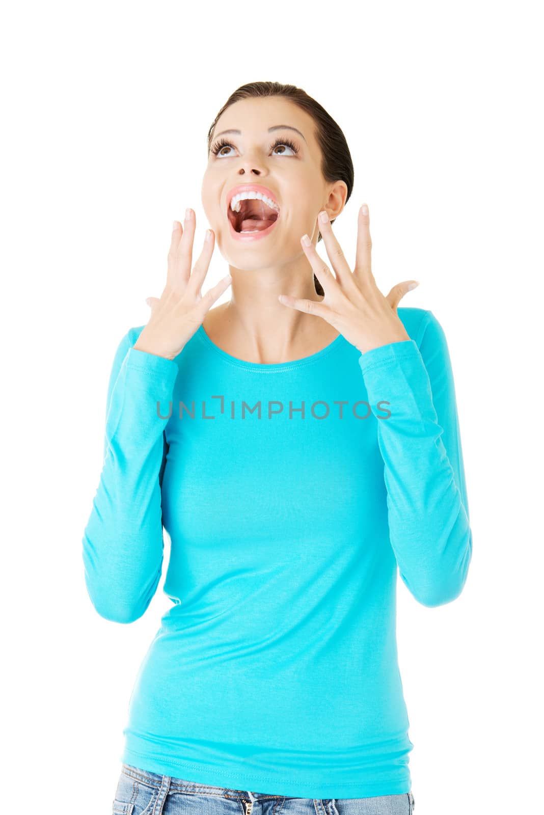 beautiful casual woman screaming, looking up. Isolated on white.