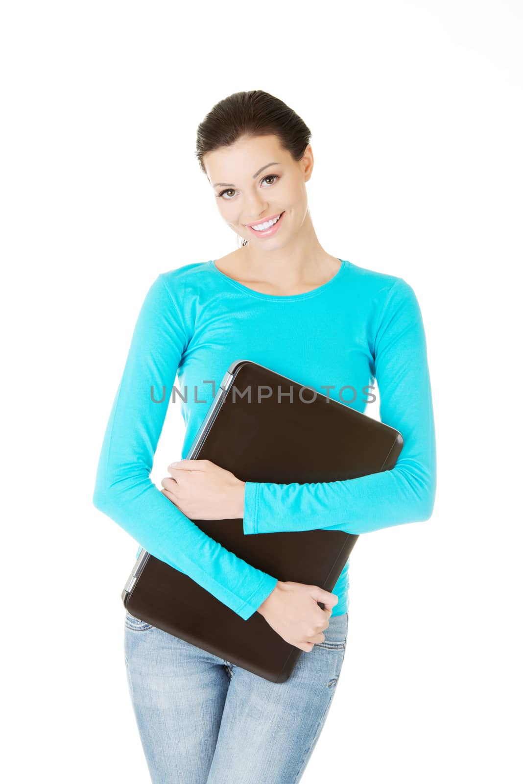 beautiful casual woman holding a laptop. Isolated on white.