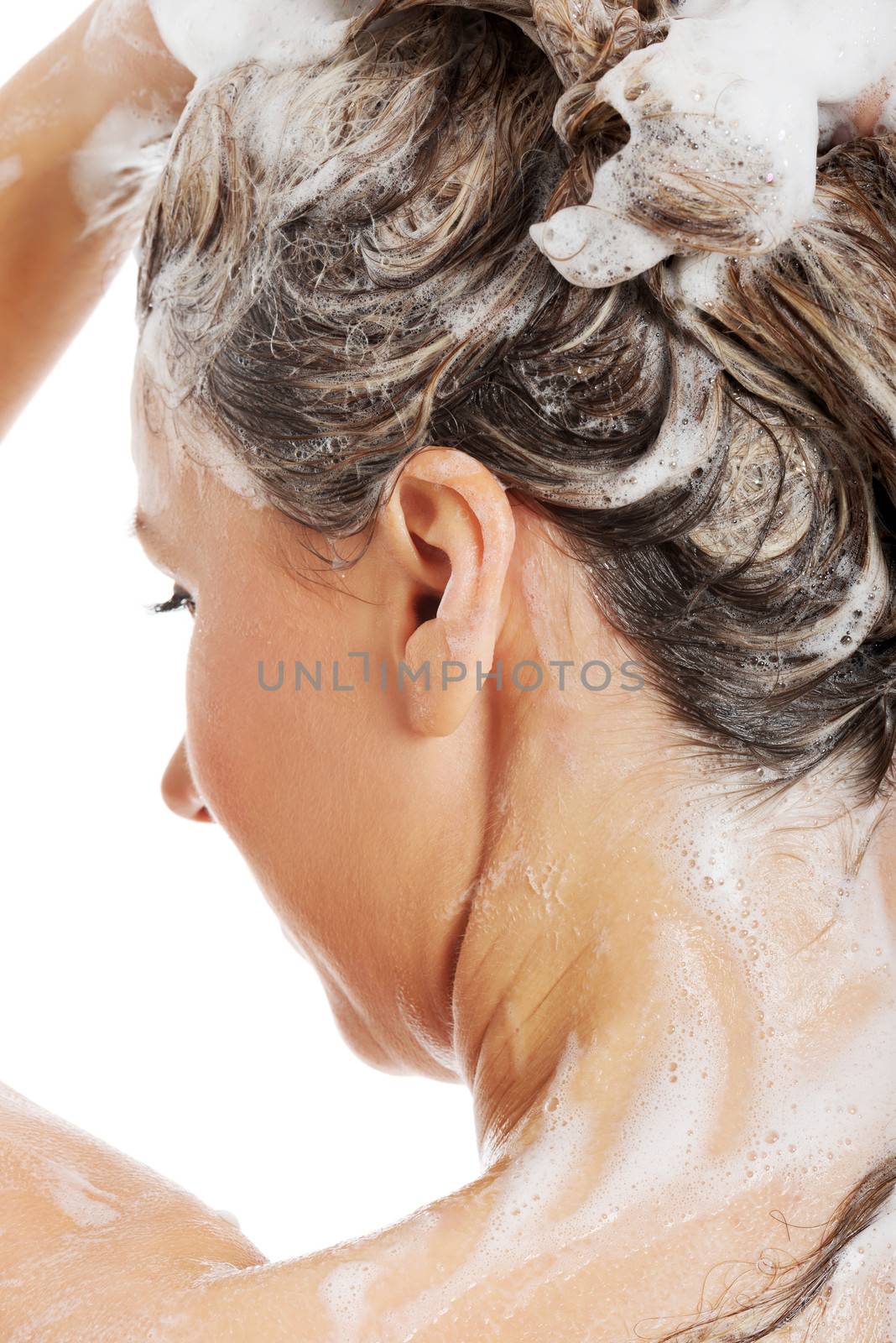 Beautiful woman taking a shower and shampooing her hair. Isolated on white.