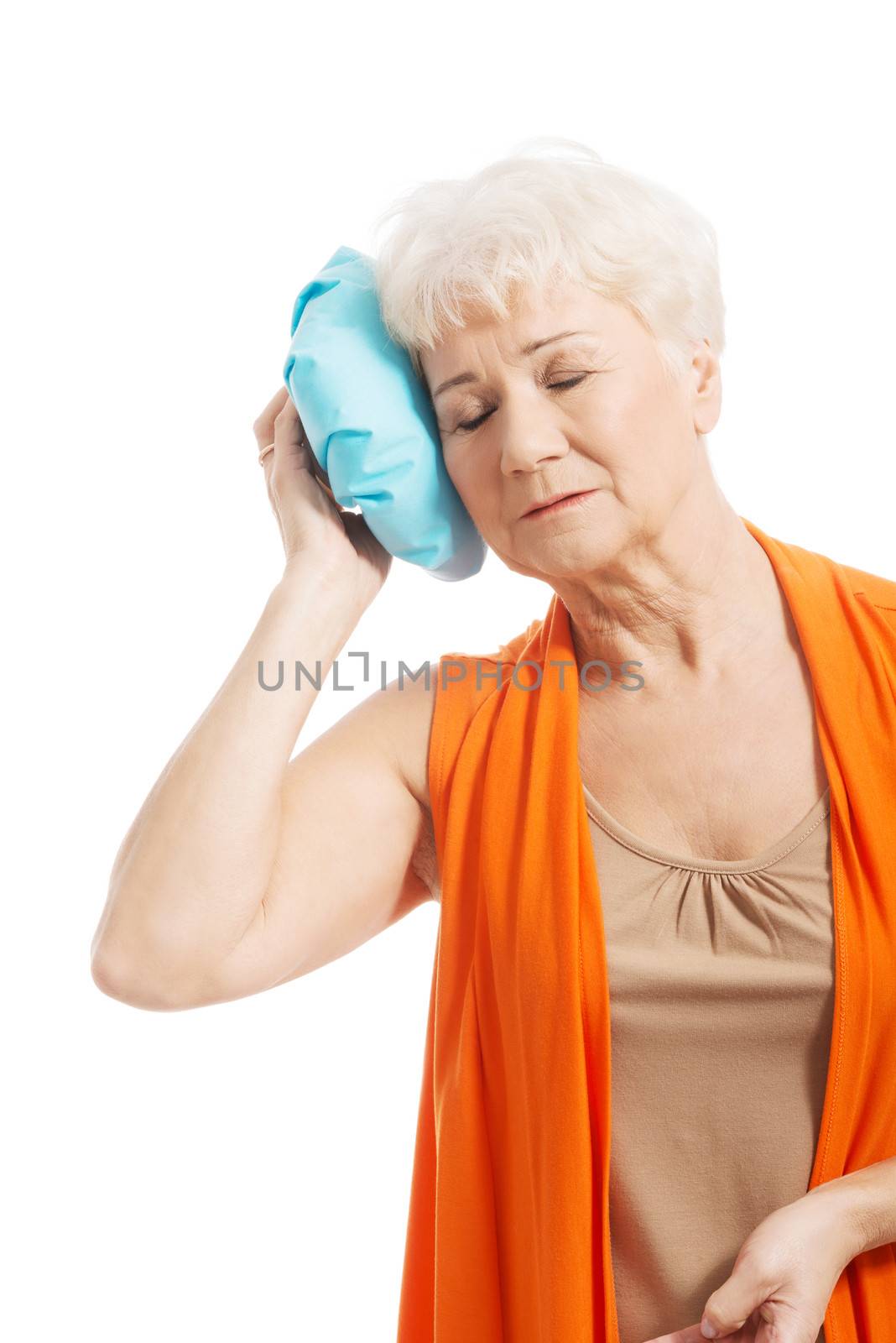 An old lady with ice bag by her head. Isolated on white.