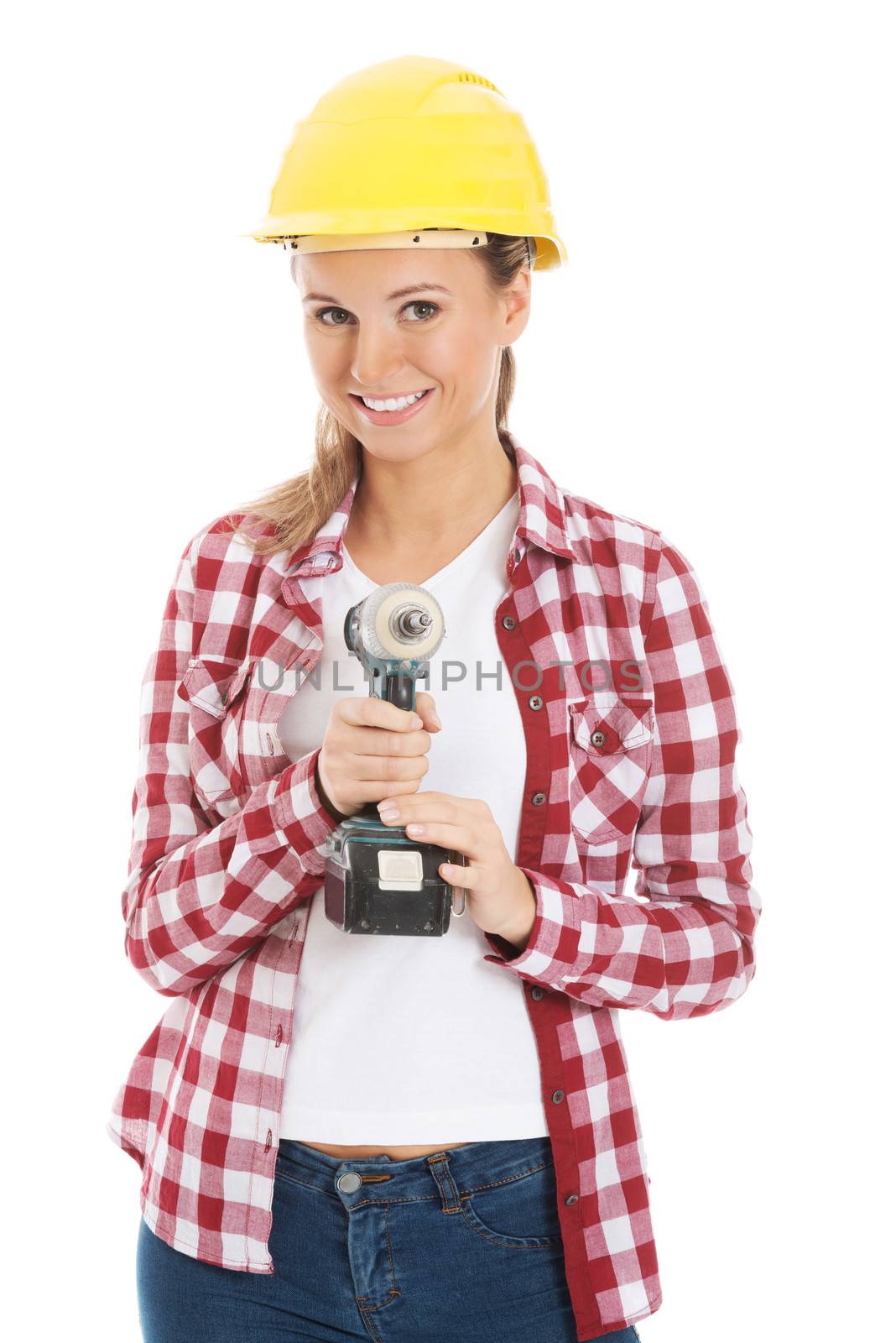 Young casual woman holding drill and wearing safety helmet. Isolated on white.