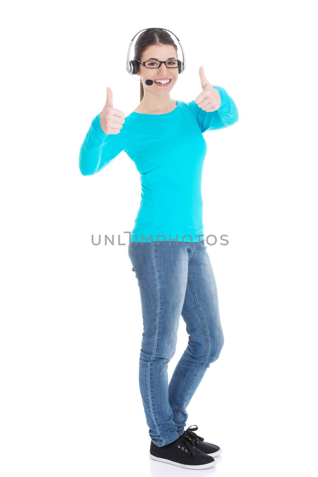 Young casual woman with headphones and microphone showing ok. Isolated on white.