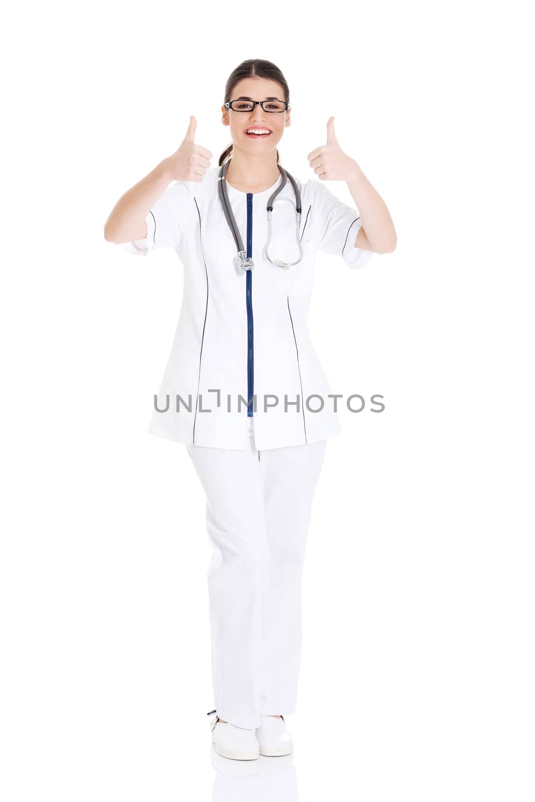 Young beautiful doctor, nurse with stethoscope showing ok. Isolated on white.