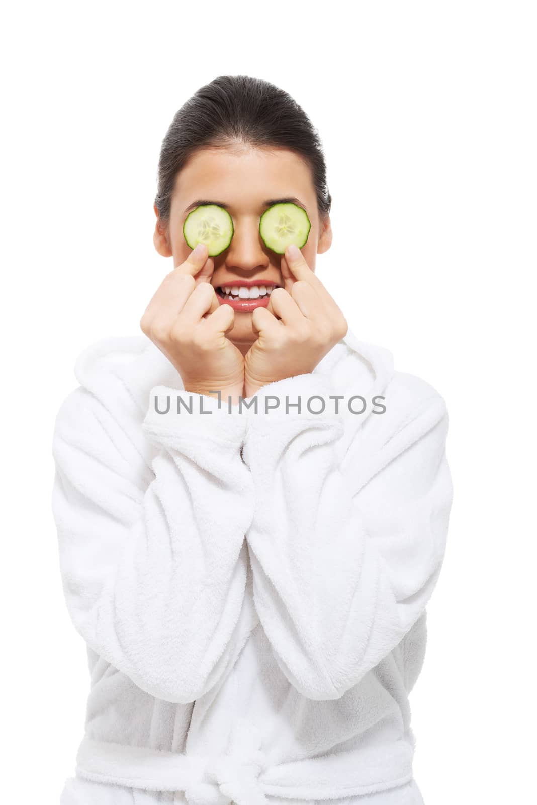 beautiful young woman in bathrobe with cucumber on eyes. isolated on white.