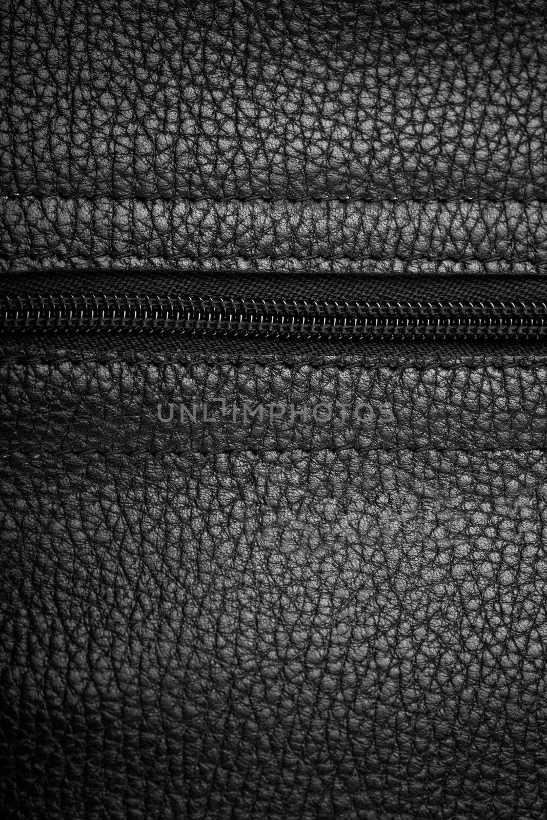 Macro view of black leather background with zipper