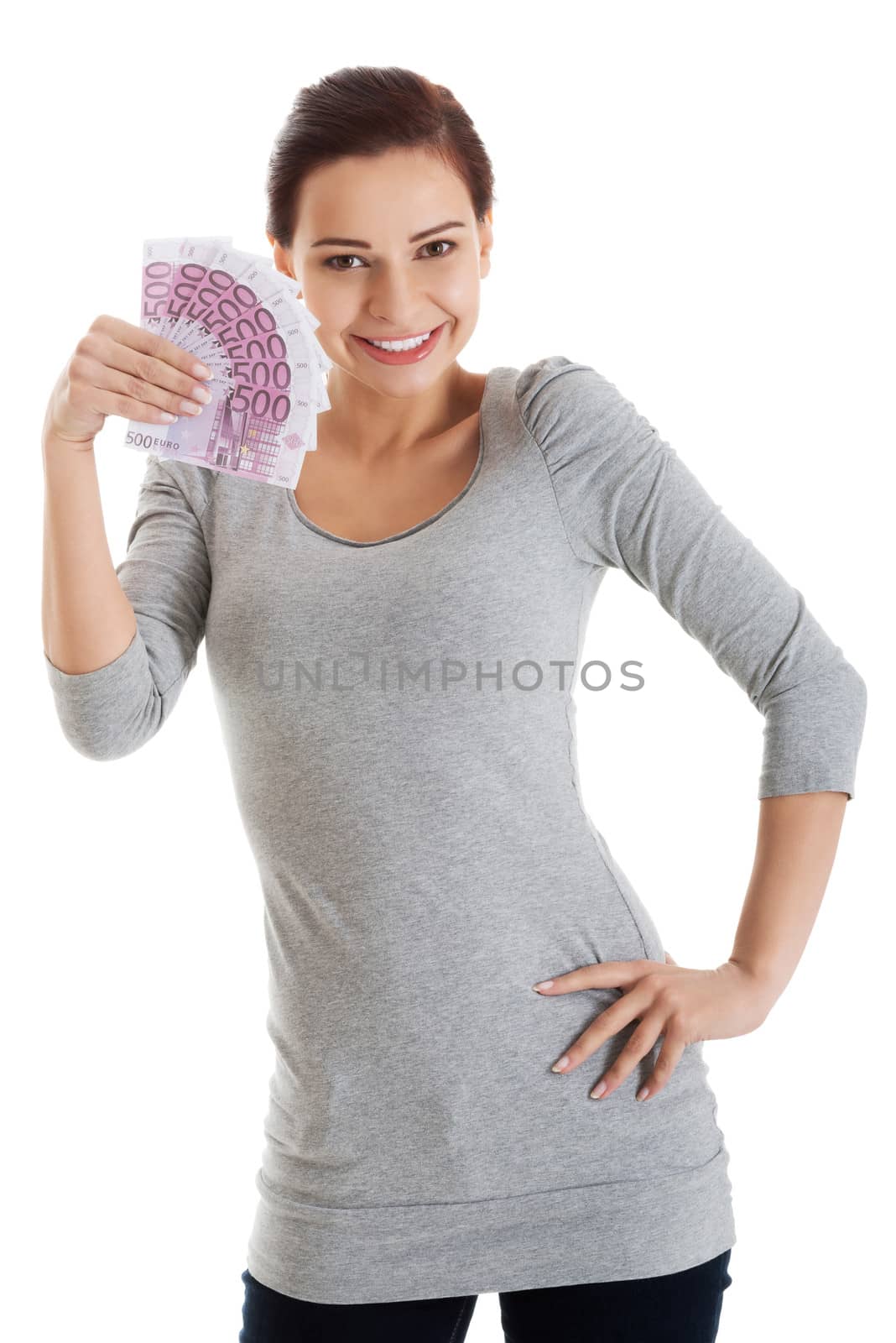 Beautiful casual woman holding money. Isolated on white.