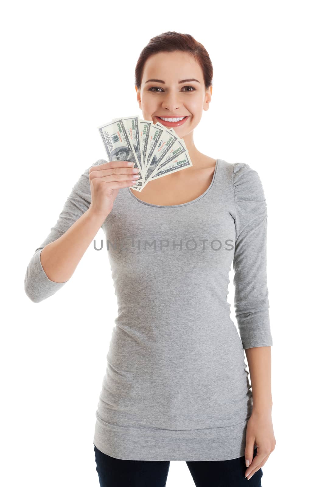 Beatiful casual woman holding money. Isolated on white.