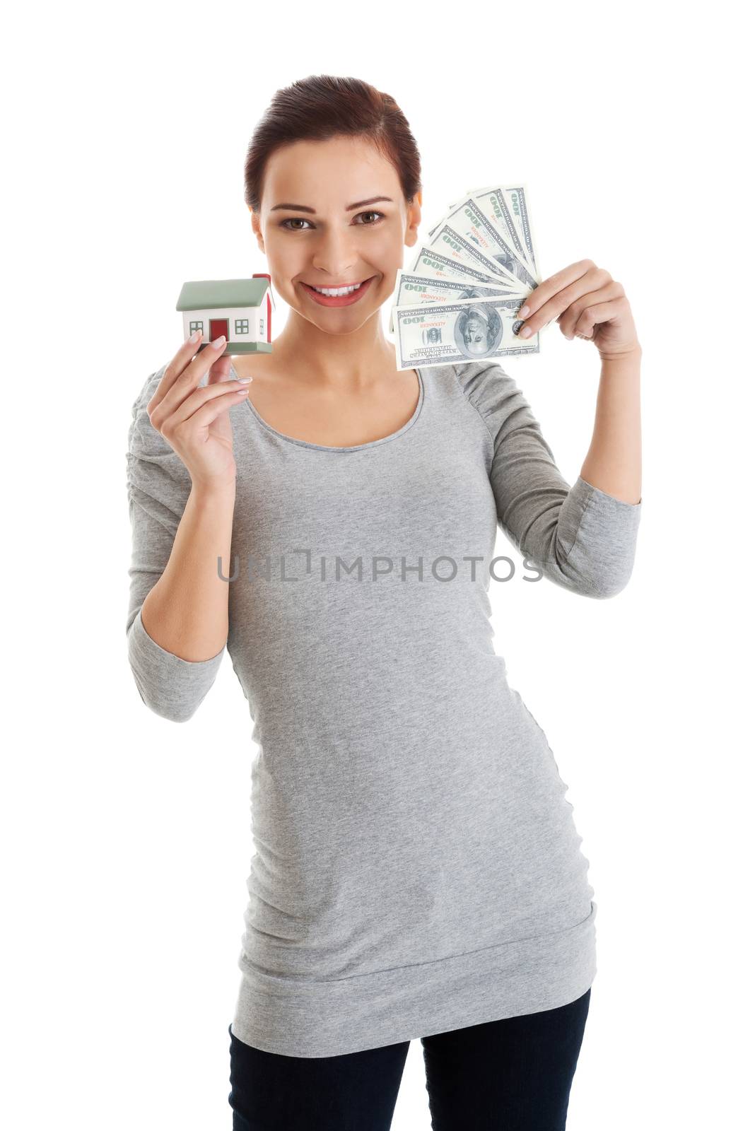 Beautiful casual woman holding money and house. by BDS