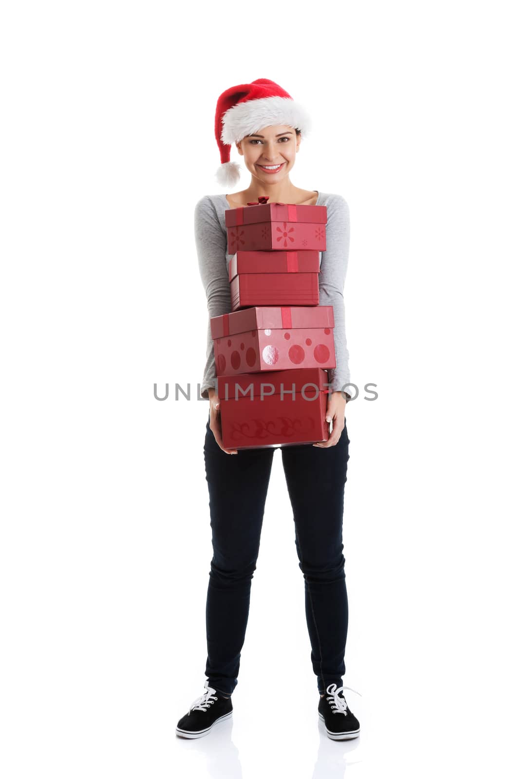 Beautifull woman in santa hat holding presents. Isolated on white.