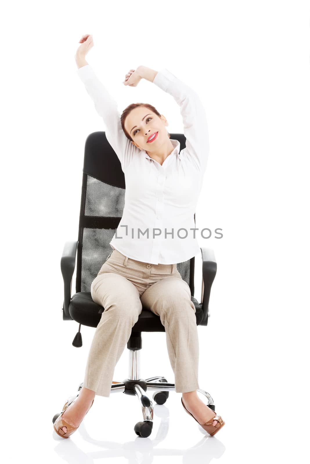 Beautiful business woman sitting and relaxing on a chair. by BDS