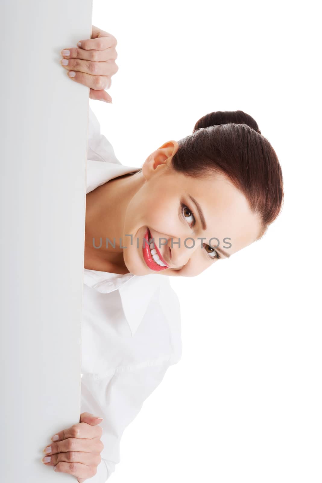 Beautiful young business woman holding copy space. Isolated on white.