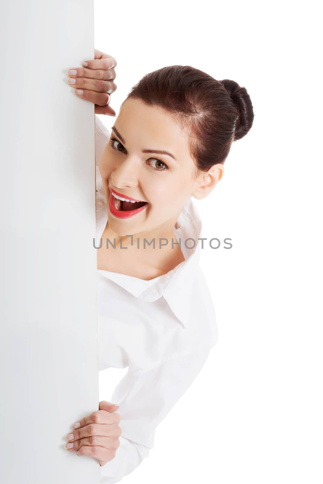 Beautiful young business woman holding copy space. Isolated on white.