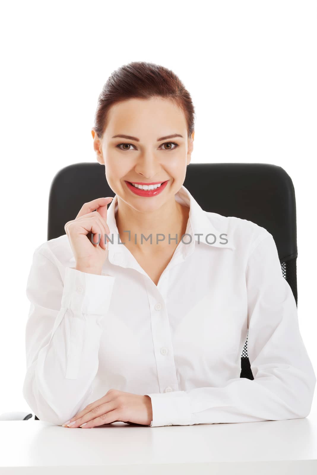 Beautiful business woman, boss sitting on a chair. Isolated on white.