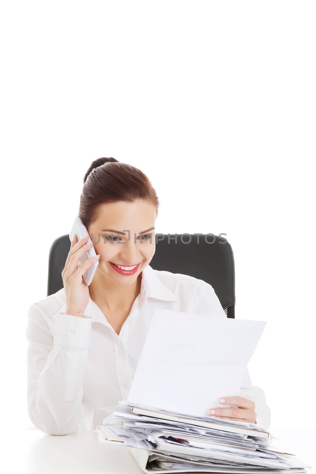 Beautiful business woman sitting and talking through phone. Isolated on white.