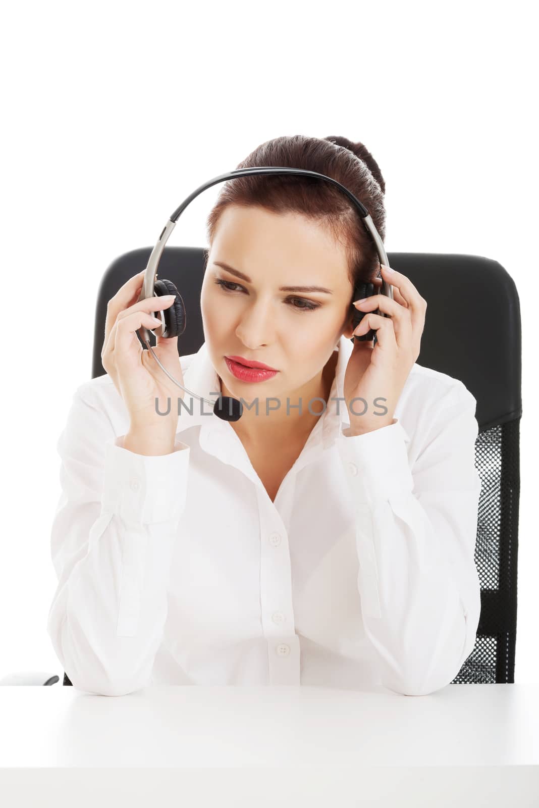 Beautiful woman sitting with microphone and headphones. Isolated on white.