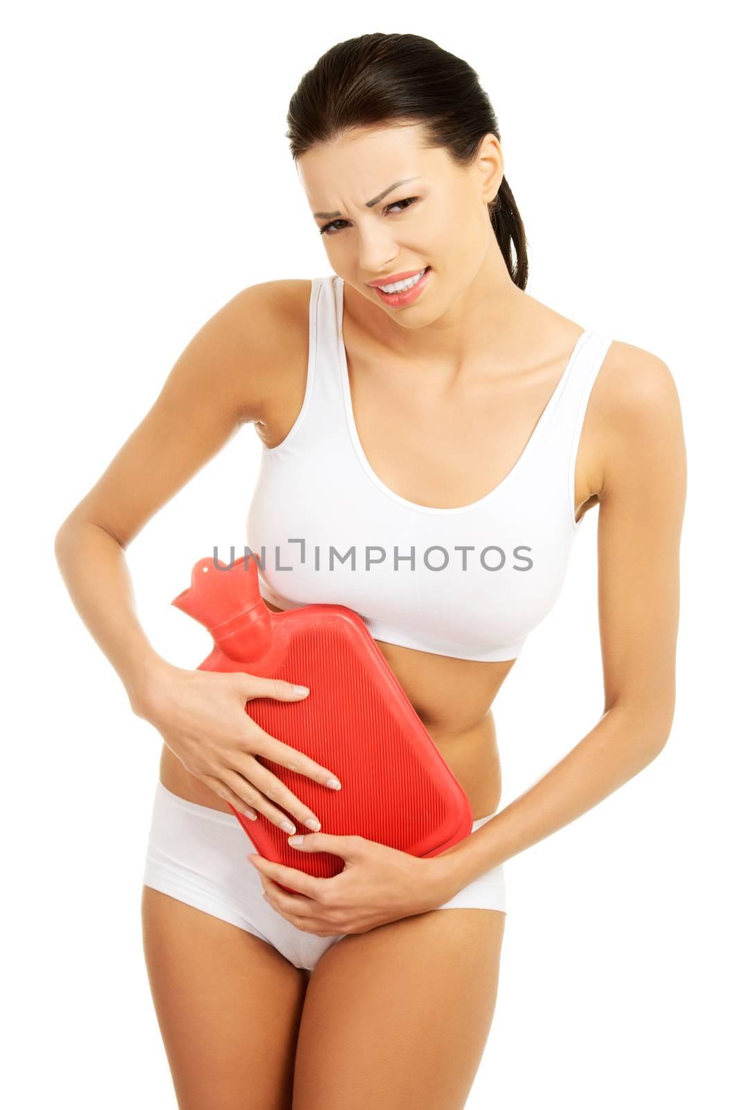 Beautiful slim woman holding hot water bottle on her belly. Isolated on white.