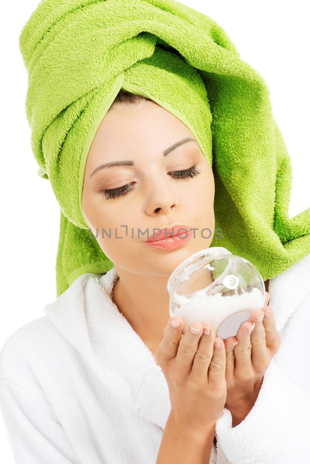 Beautiful woman in bathrobe, turban and holding face cream. by BDS