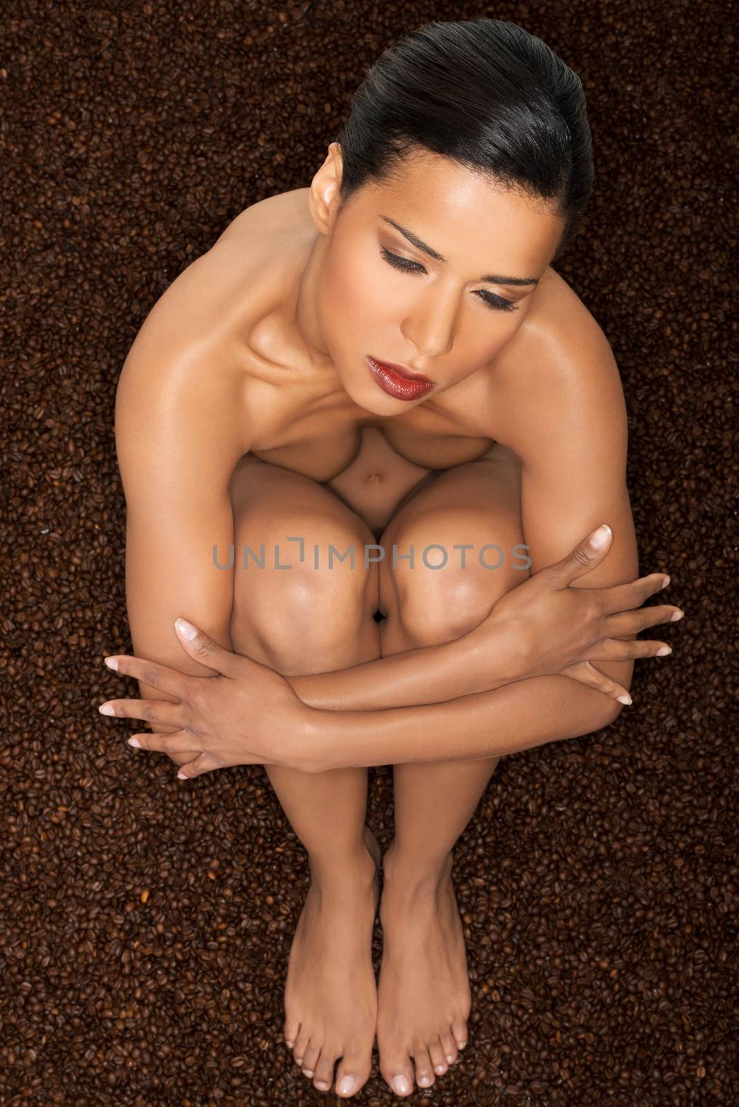 Beautiful naked woman on coffee beans. by BDS