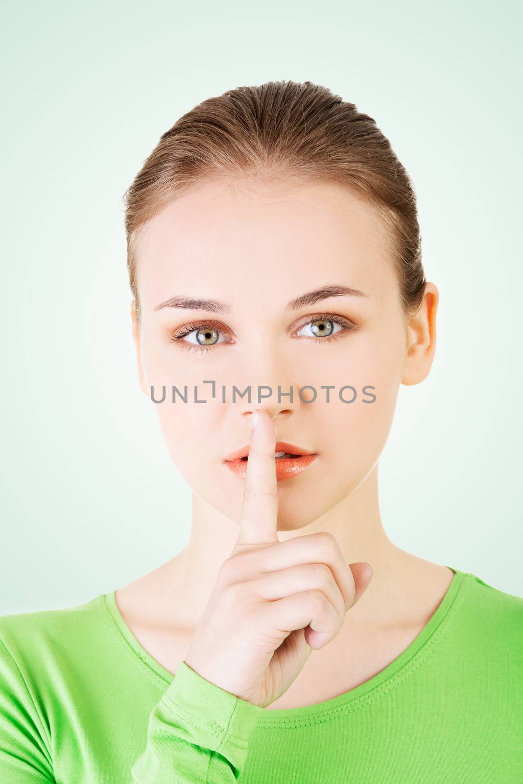 Hush be quiet woman. Teen girl with finger on her lips.