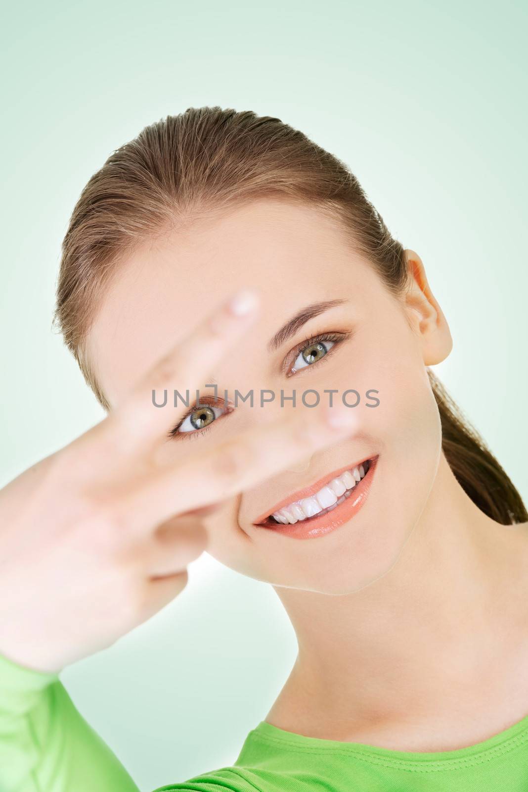 Happy teenager girl showing victory sign by BDS