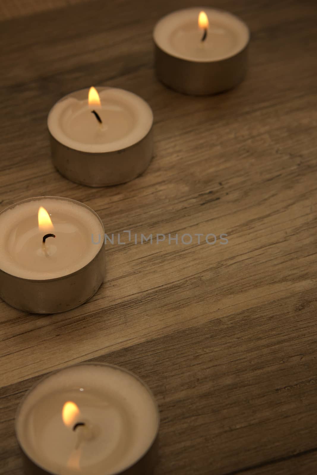 several tealights with wooden background