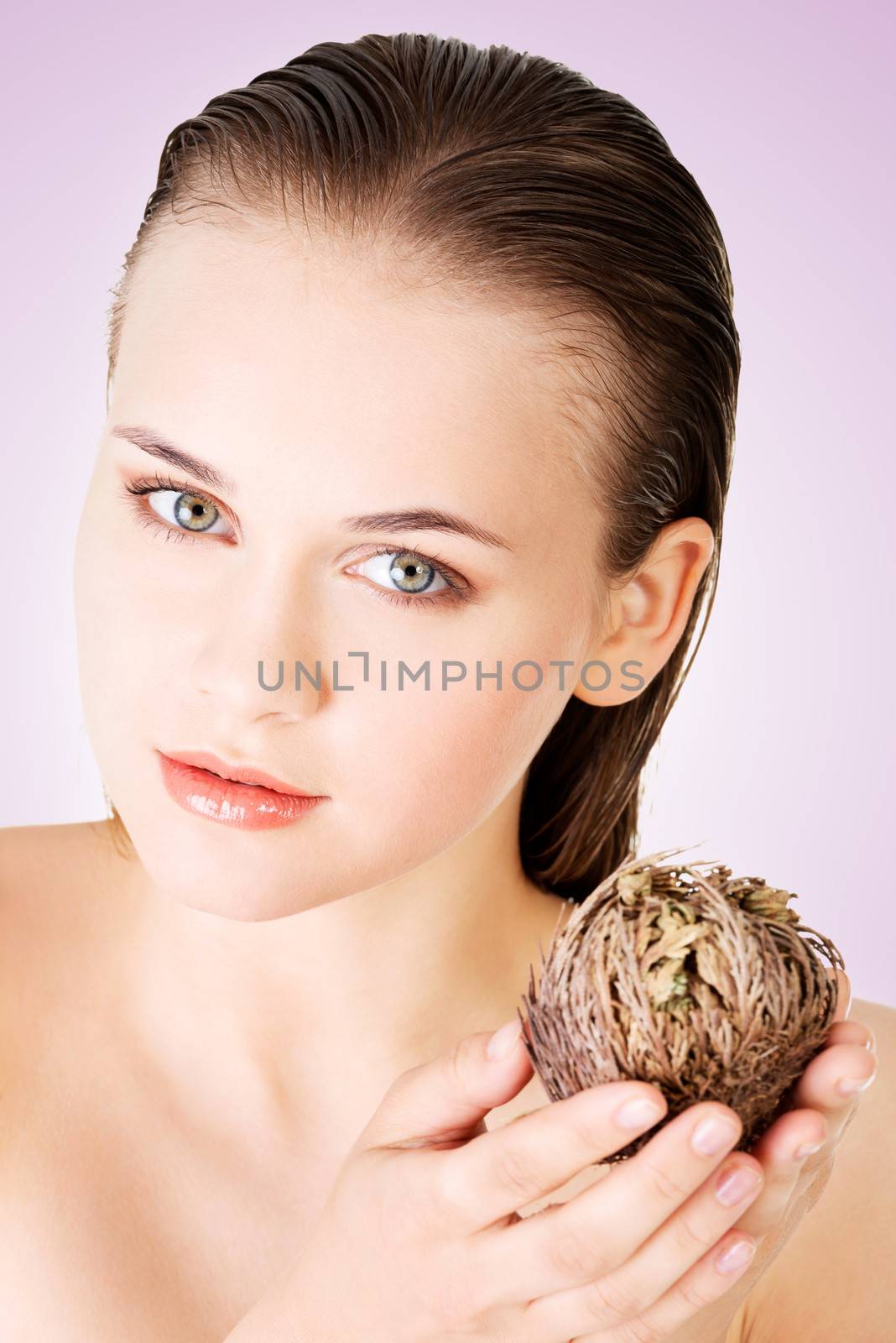 Beautiful spa woman holding Rose of Jericho