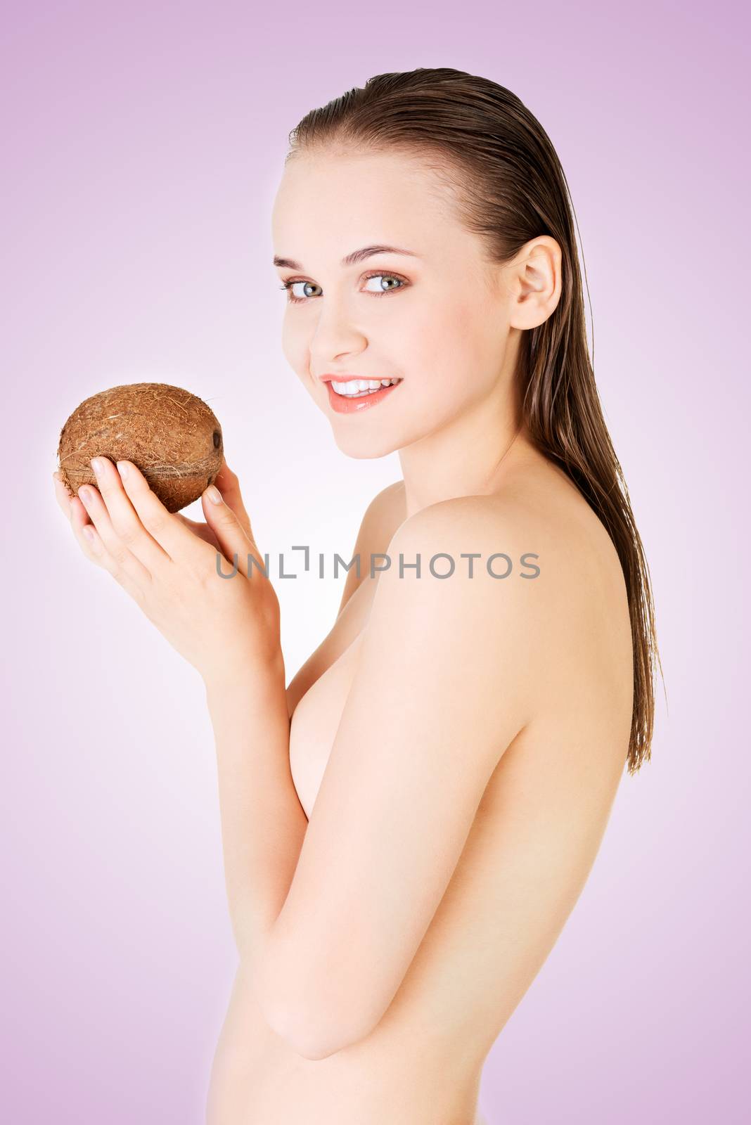 Beautiful woman with coconut in hands