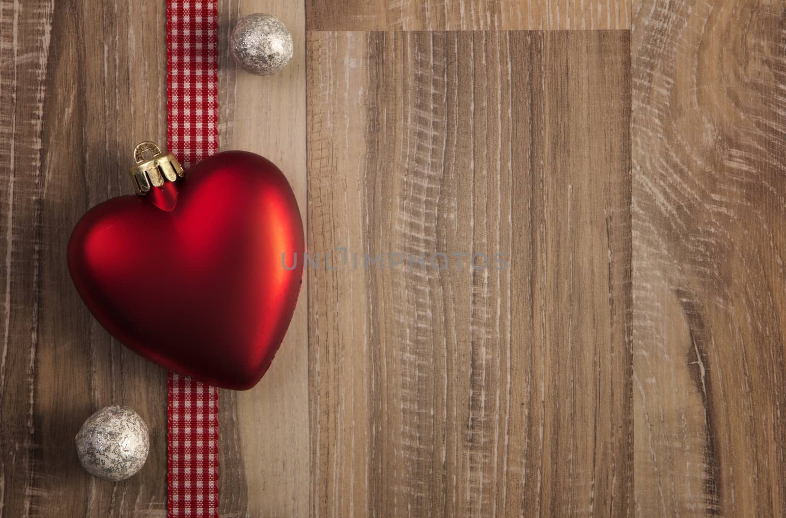 heart as christmas bauble with wooden background 