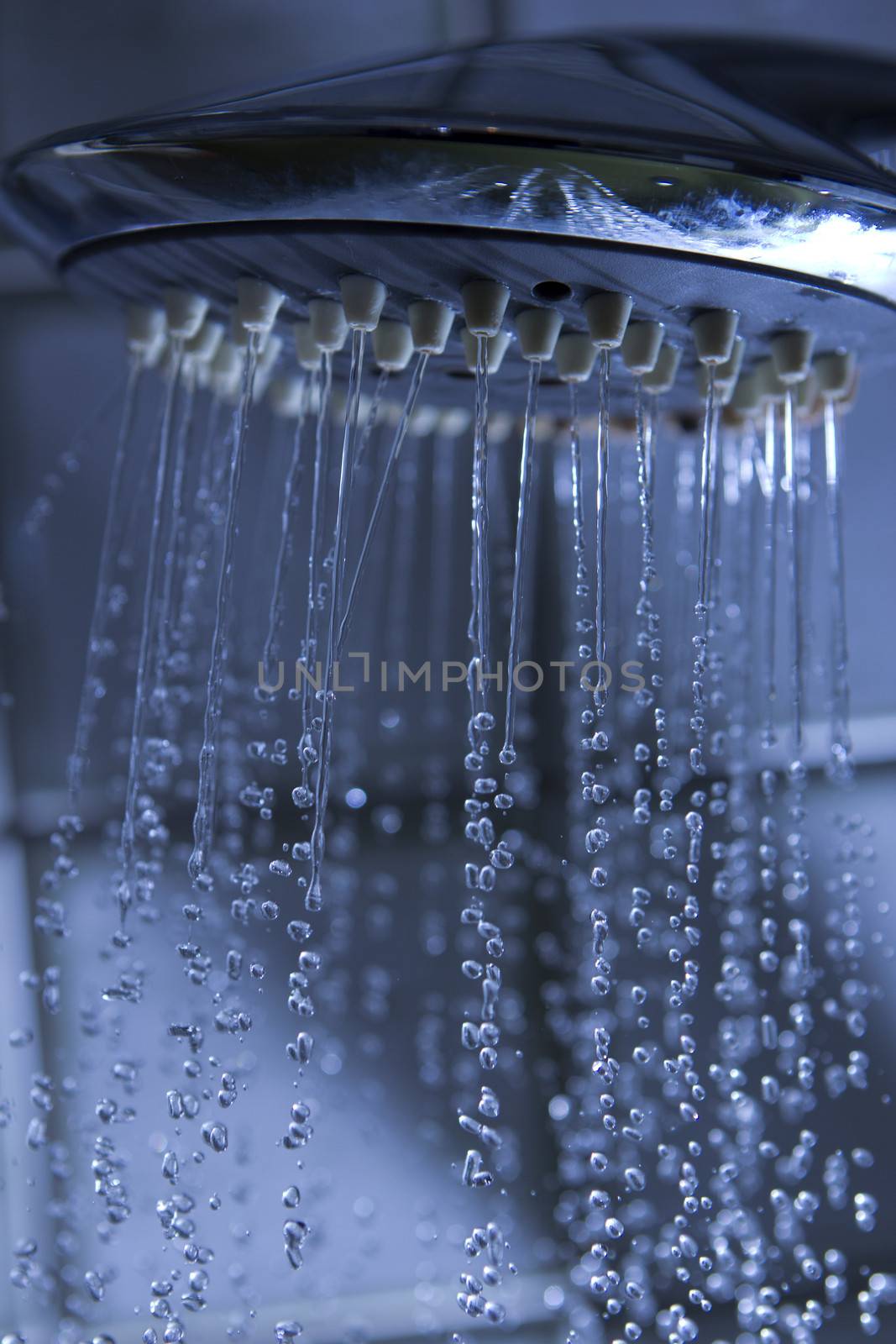 running water from a shower head with water drops
