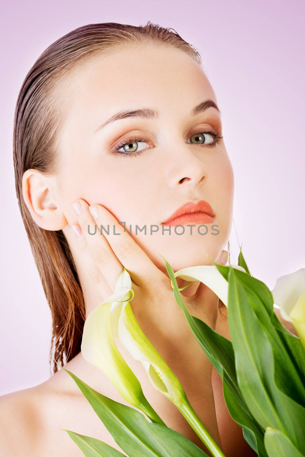 Beauty face of the young beautiful woman with flower.