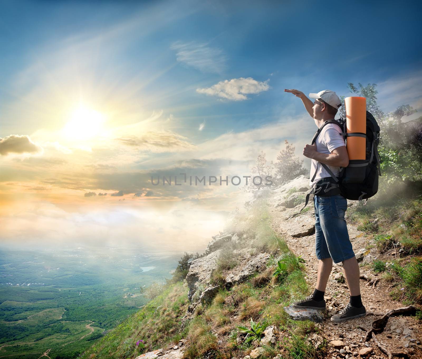 Tourist on the mountain looking at the sun