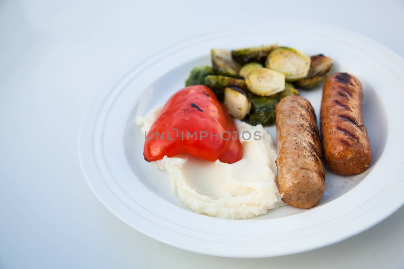 BBQ grilled sausages with mash potatoes and vegetables