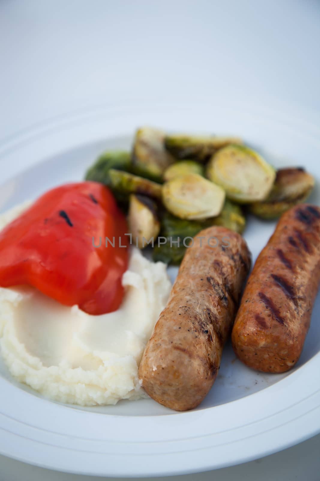 BBQ grilled sausages with mash potatoes and vegetables